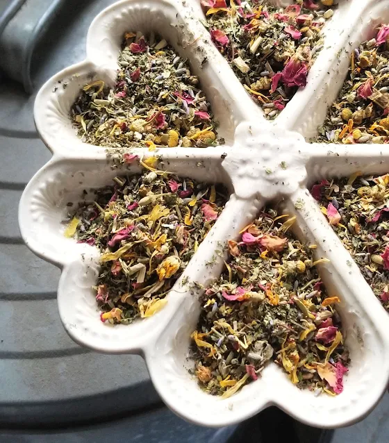 dried herbs in heart-shaped ceramic dish