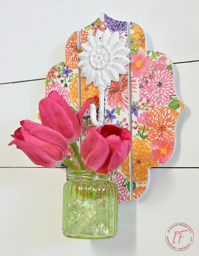 This DIY Decoupage Wall Sconce is an easy dollar store craft for Spring or Summer and can be used as a mason jar candle holder lantern or hanging flower vase.
