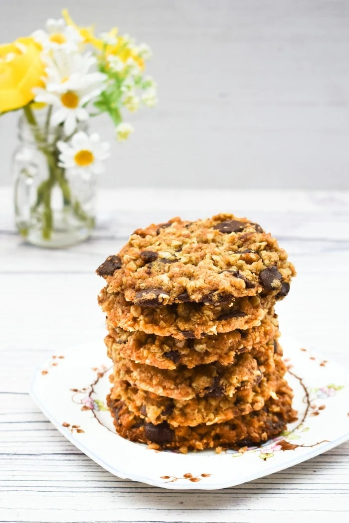 Stack of chocolate chip oat cookies on a floral square teaplate