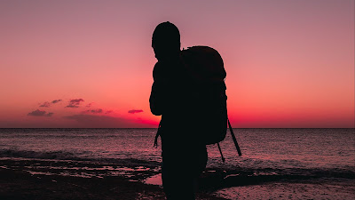 Lonely man, beach, backpack, silhouette Lonely man, beach, backpack, silhouette