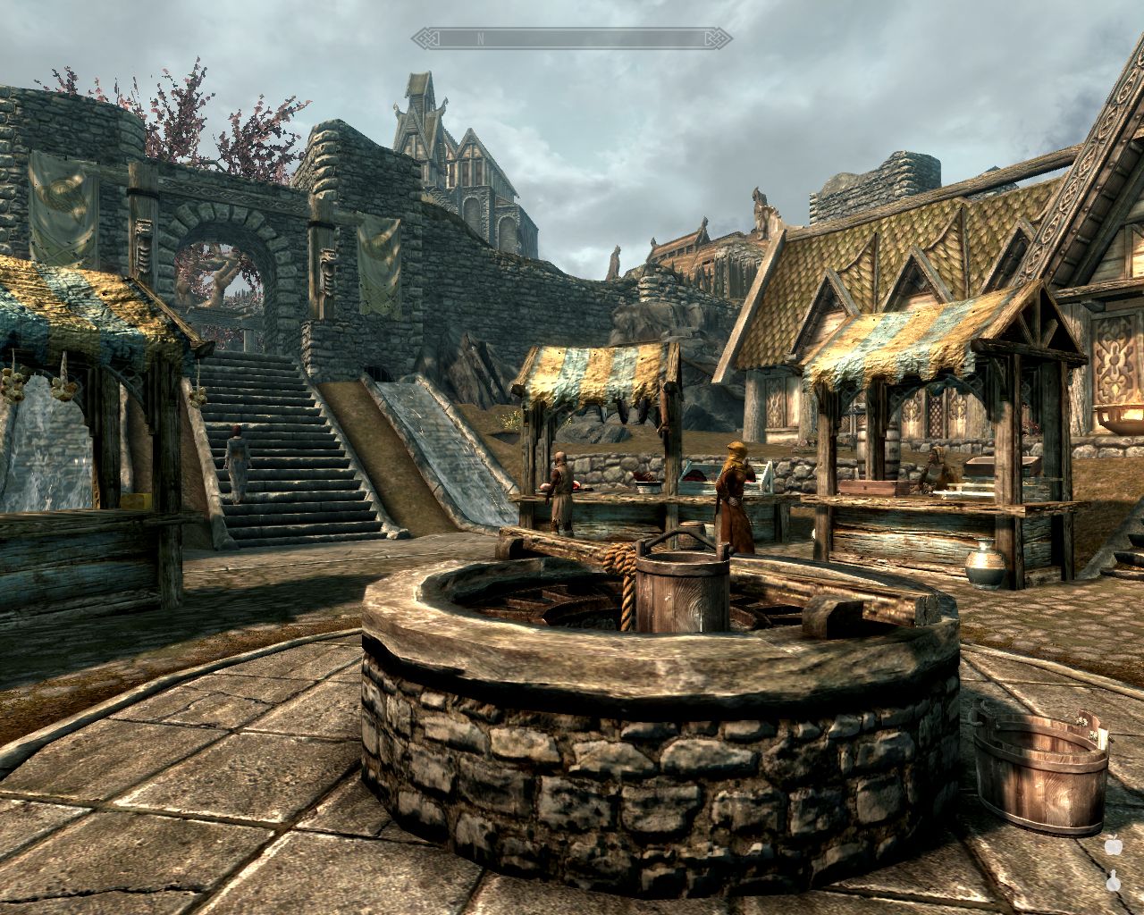 Hviterun marketplace, well in the foreground, three market stalls, Ysolda walks up the stairs on the left