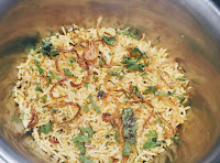 Layering rice over vegetables for veg biryani recipe