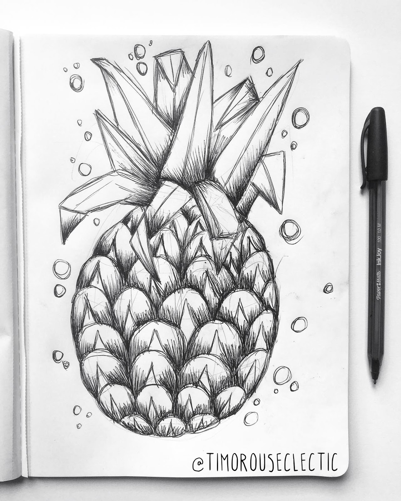 Sketchbook page showing a ballpoint pen drawing of a pineapple