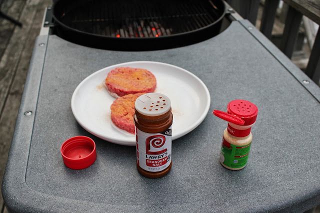 Seasoning burgers with Lawry's Seasoned Salt and McCormick Garlic Powder