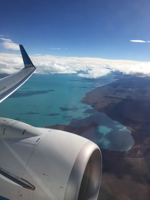 Patagonia: Like Falling in Love. Blue lakes of Patagonia as we fly over plane flying above arid plains and blue lakes