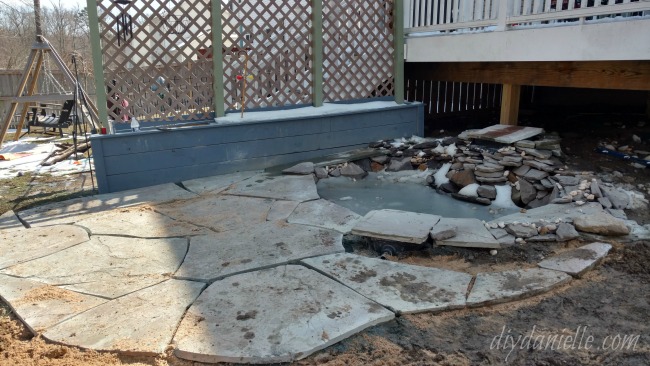 Stone laid for the patio around the pond. Stone laid for the patio around the pond.