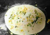 Flatten garlic butter naan dough topped with chopped garlic