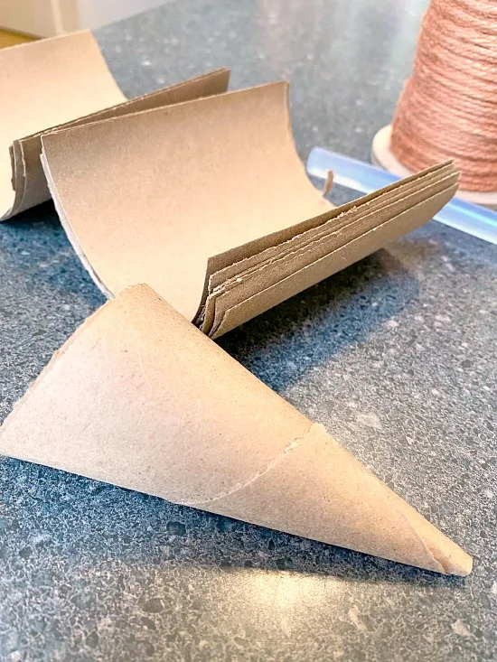 Rolling a cardboard cone for DIY Jute Carrots