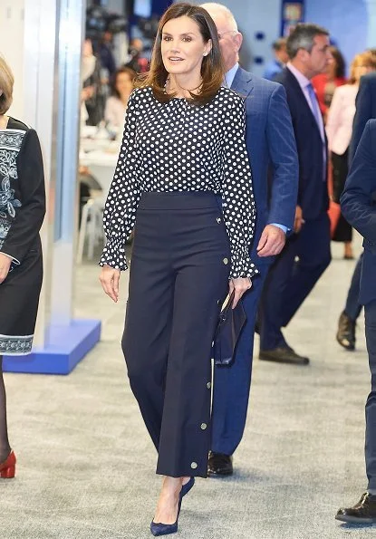 Queen Letizia wore a ecru polka dot silk top by Carolina Herrera, and a navy blue high waist wide leg  trousers by Hugo Boss