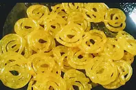 Drained jalebi from sugar syrup for jalebi recipe