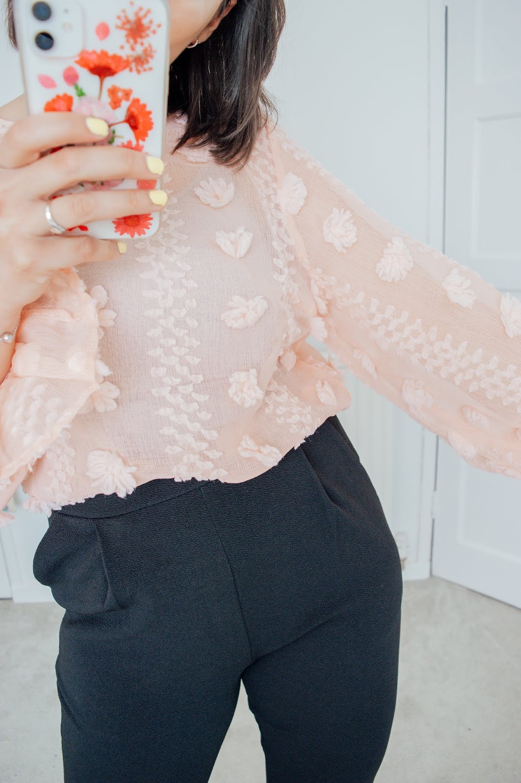 What Workwear I Bought from Shein -- What Workwear I Bought from Shein - What Workwear I Bought from Shein - Pink Flounce Sleeve Blouse Person holding a phone wearing a pink blouse and black trousers.