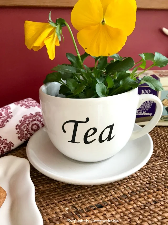 Pretty Tea Cup planter with pansies inside and tea on cup su