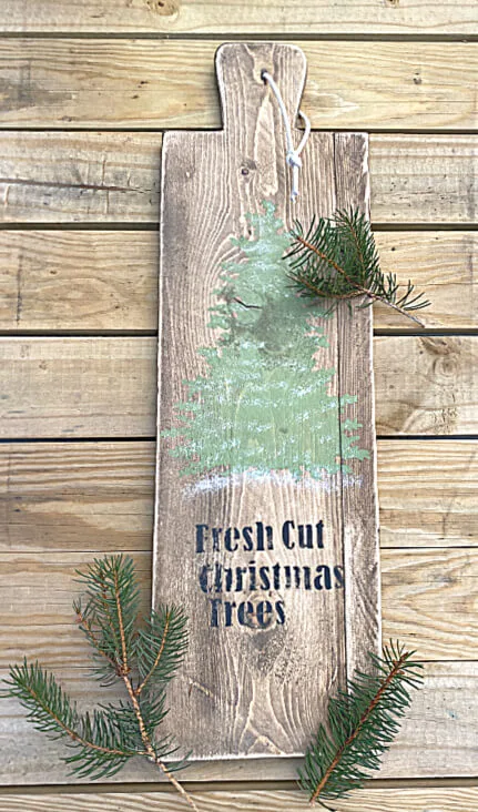 Christmas tree stenciled bread board with pine boughs