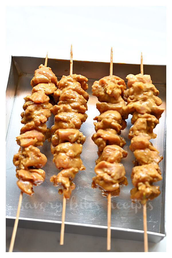 thai coconut chicken skewers arranged on a tray