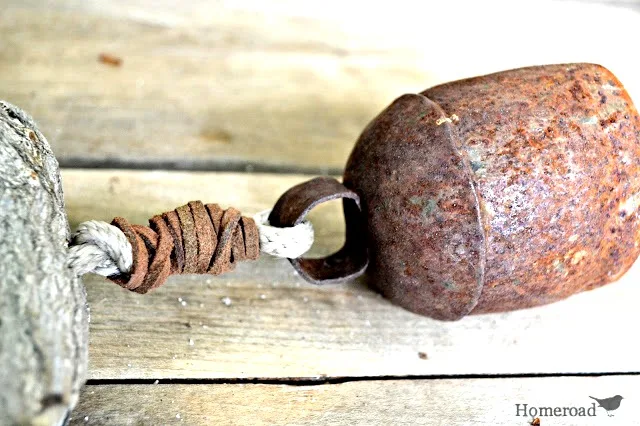 Rusty bell attached with leather on rope