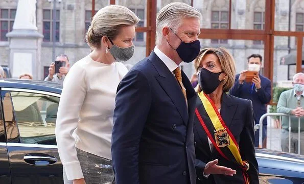 Queen Mathilde wore a new sequined Prince of Wales checked wool straight-leg pants, and white cashmere round neck sweater, diamod earrings