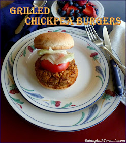 Grilled Chickpea Burgers come together in the food processor. They’re full of vegetable flavor enhanced by charring them on the grill. | Recipe developed by www.BakingInATornado.com | #recipe #dinner