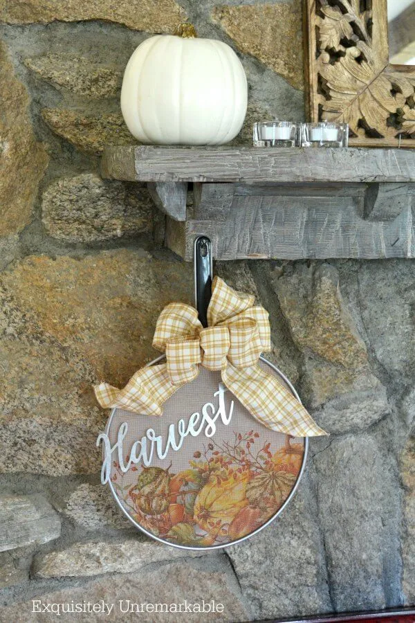 Splatter Screen Wreath on a stone fireplace with pumpkin on mantle