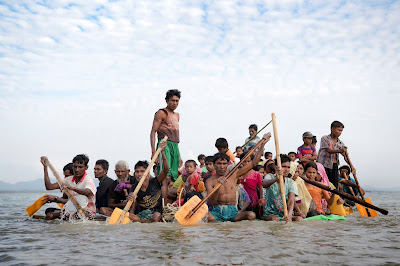 Rohingya refugees crossing into Bangladesh on makeshift rafts constructed of bamboo and plastic palm oil containers.