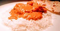 Serving chicken tikka masala over rice and naan for restaurant style chicken Tikka masala recipe