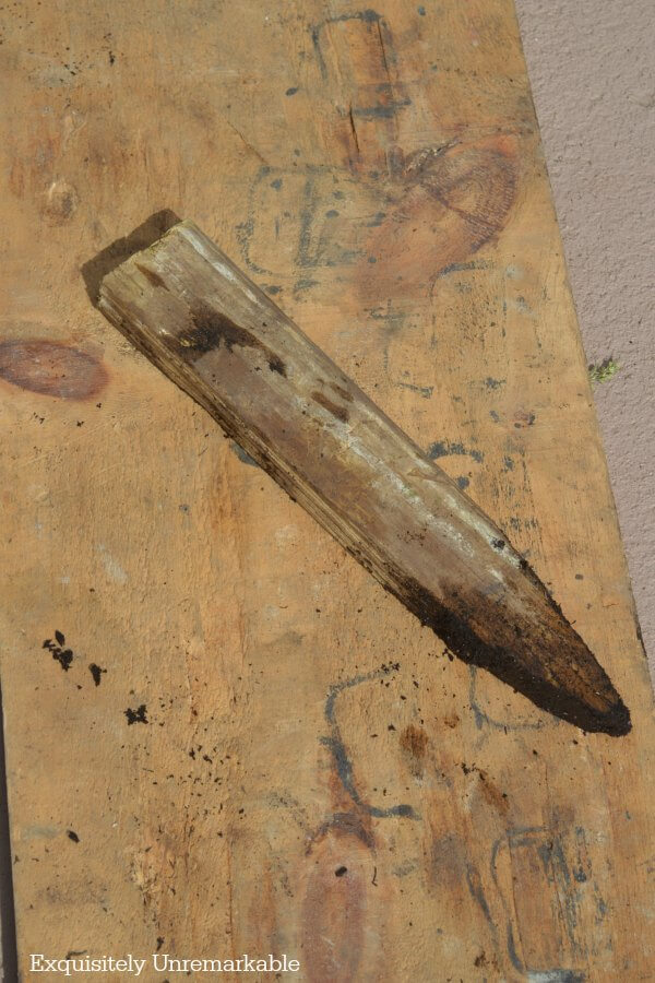 Simple wooden gardening stake on wood