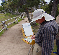 Painter with easel in Yellowstone National Park painting natural beauty