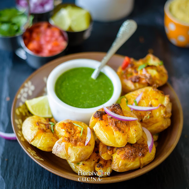 Air Fried Masala Smashed Potatoes in a plate with cilantro chutney