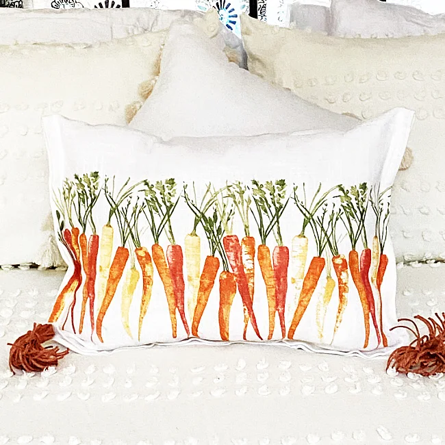 carrot pillow on a bed