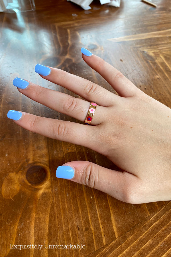 Woman's hand with blue impress color nails