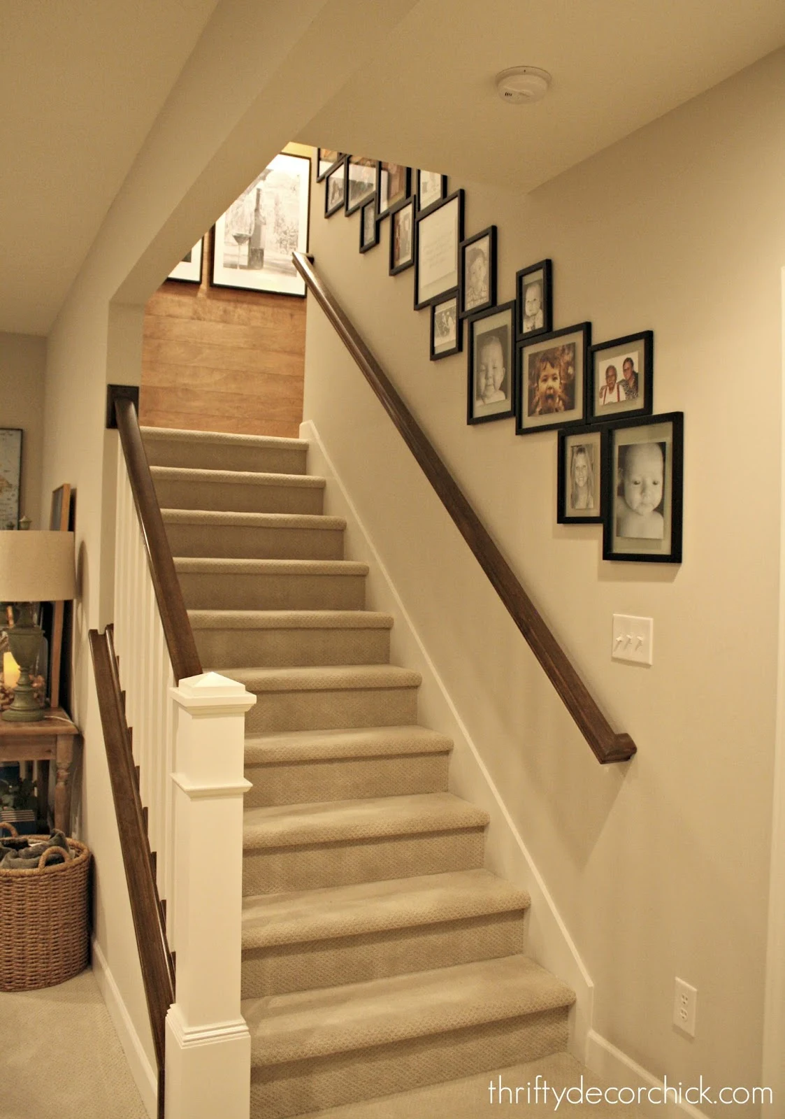 Gallery wall on stairs with wood accent wall