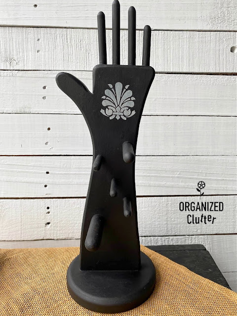 Photo of a black wooden hand shaped jewelry holder