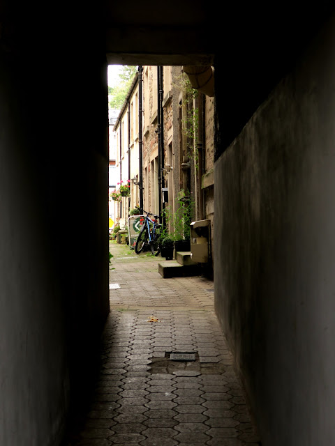 Entrance to wynd in Jedburgh with bicycle and houses in view. 19th September 2021