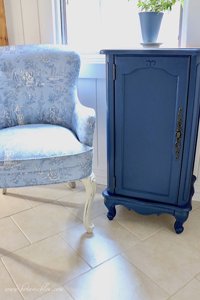 Add French Country style to a room with a blue toile chair and a navy painted Provence style floor cabinet