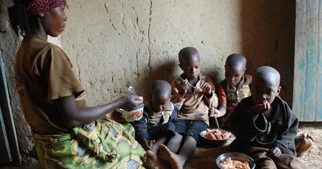 A Mother feeding his kids in the Rural Kenya