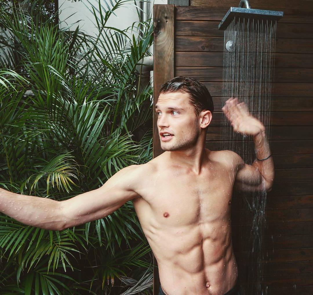 fit-shirtless-guy-showering-outdoors-summer