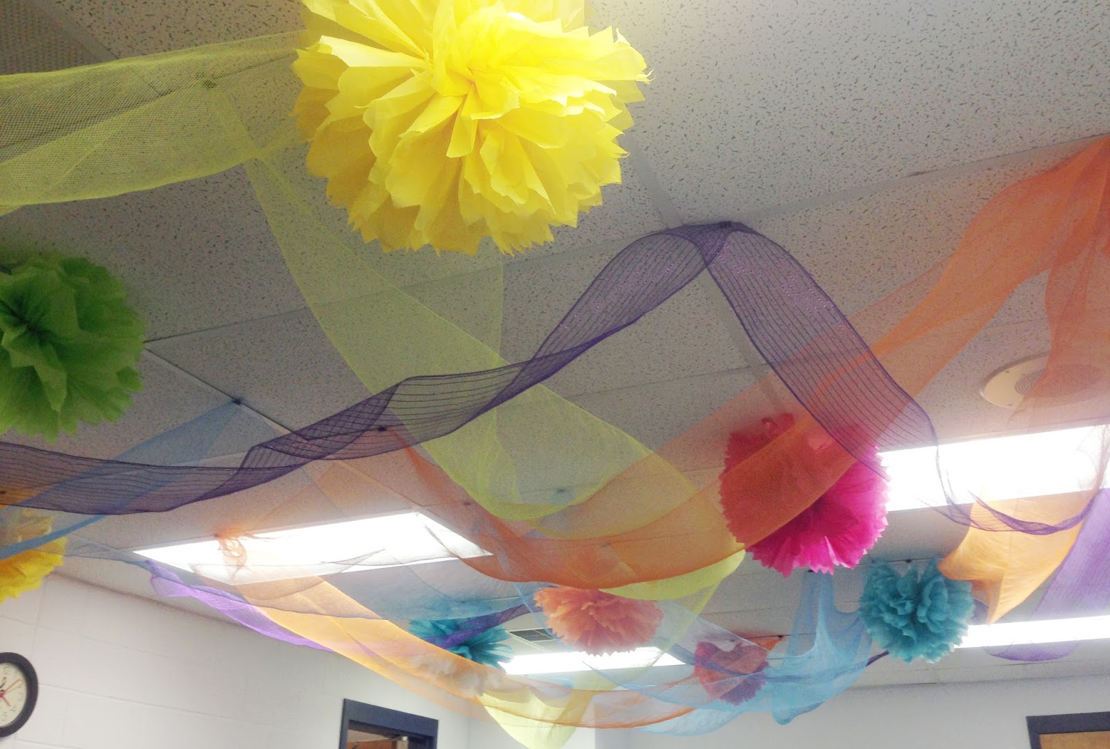 Dancing Commas :: Workshop of Wonders VBS :: Tissue paper pom poms and decorative mesh hung from ceiling