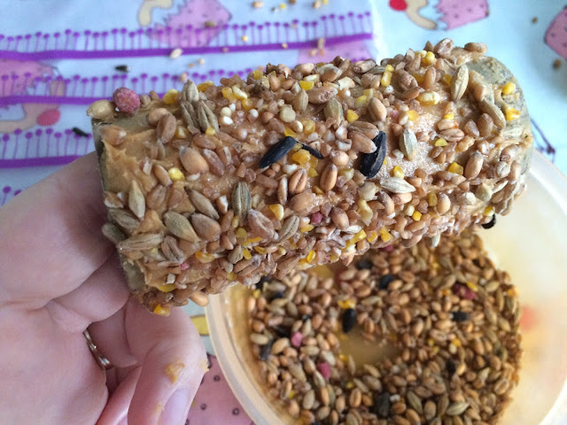 The roll covered in peanut butter and bird seed