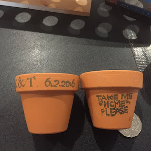 I made rustic personalised stamps for the couple and used them on terracotta pots