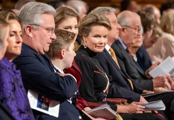 Queen Mathilde wore a floral print gown by Dries Van Noten. Crown Princess Elisabeth wore a velvet-satin jumpsuit by DVF