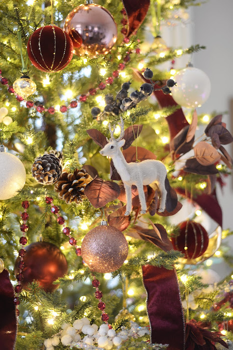 Living room decorated for Christmas with red and white Christmas tree. Canadian Tire mulberry collection Christmas ornaments. Red velvet christmas ribbon