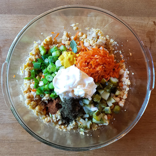 Chickpea salad sandwich ingredients in a large mixing bowl