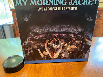 Photo of a puzzle box that has a picture of a band from the back of a stage. It says "My Morning Jacket."