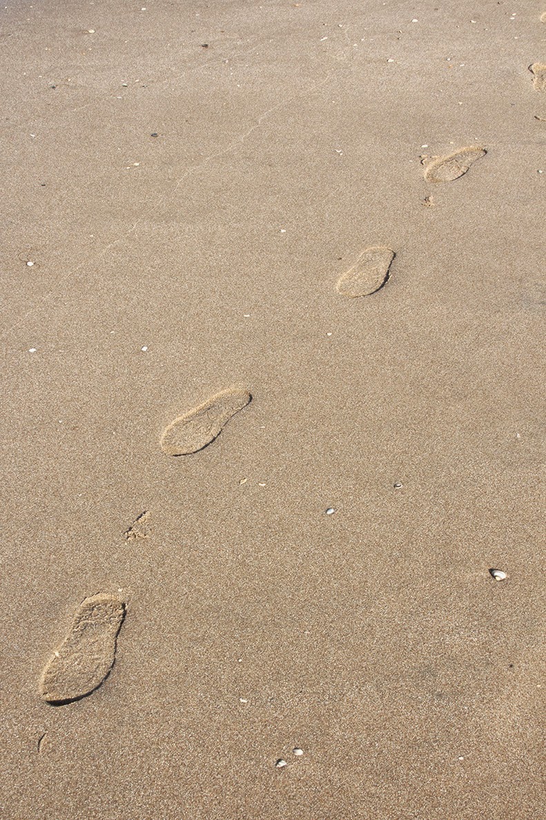 trail of footsteps in sand