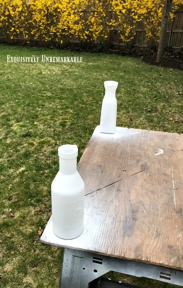Spray Painting Glass Bottles in the backyard