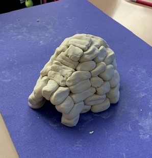 mentoring in the middle, an igloo made by a student from clay