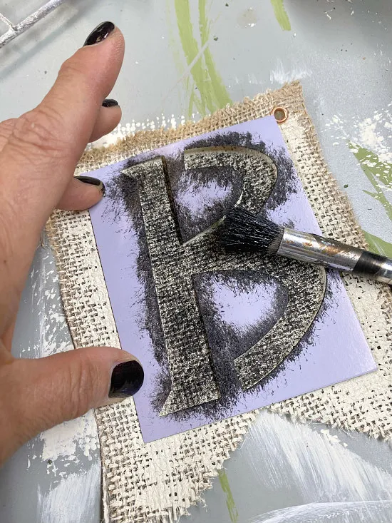 Stenciling a B on a burlap flag