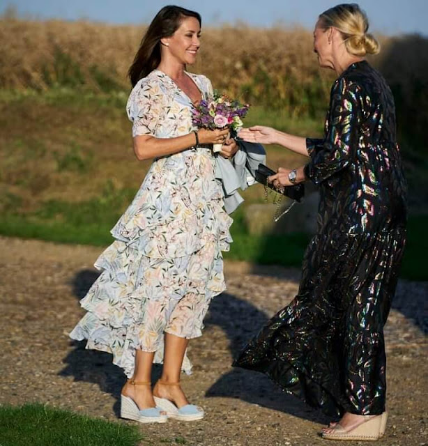 Princess Marie wore a new ruffle floral-print crepe midi dress from Maje. Dior clutch