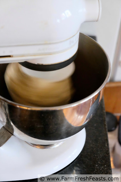 mixing up honey semolina wheat pizza dough in a stand mixer 