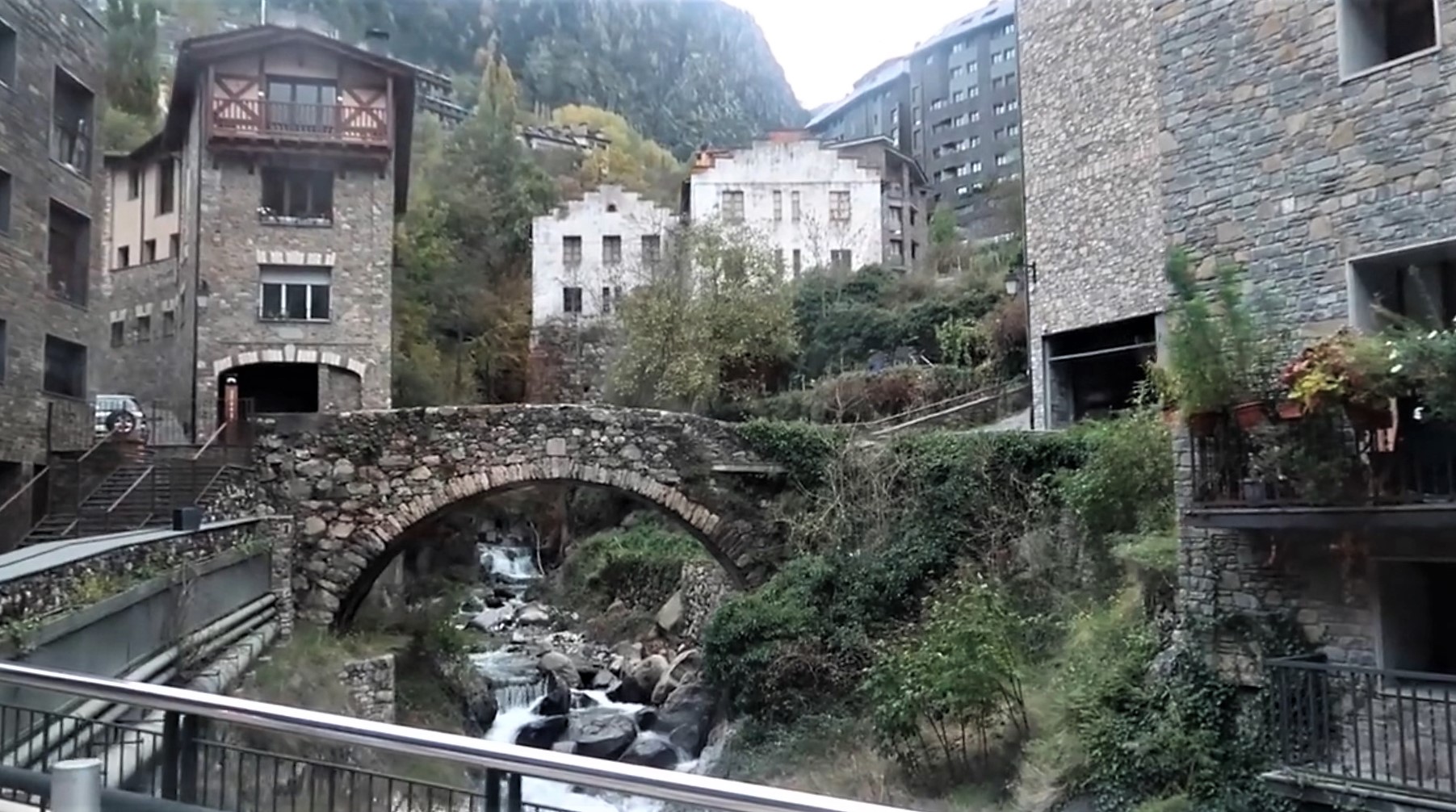 Old stone bridge over the river in old quarter of Andorra la Vella city
