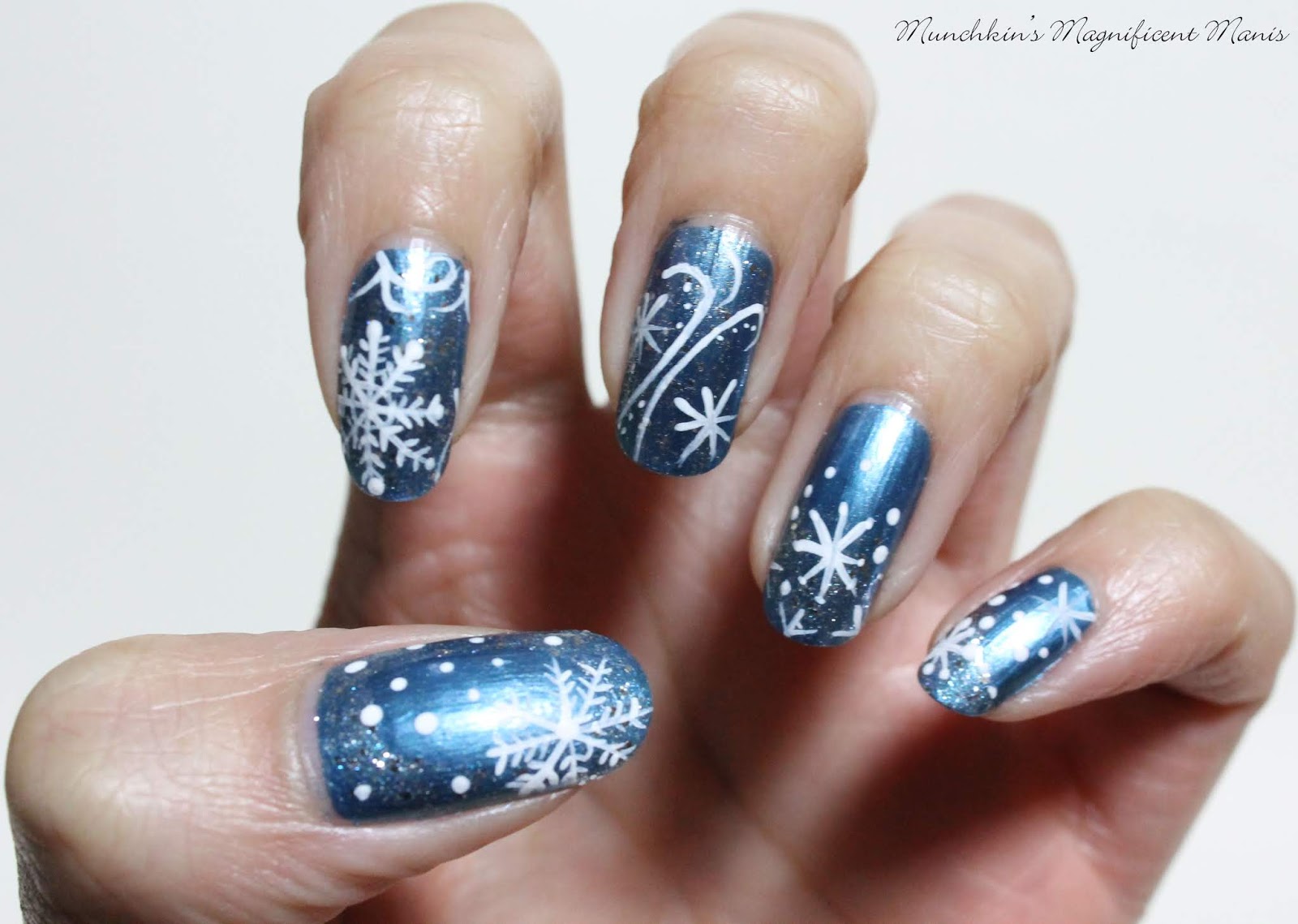 5. Dark Blue and Silver Glitter Snowflake Nail Design for Winter - wide 3